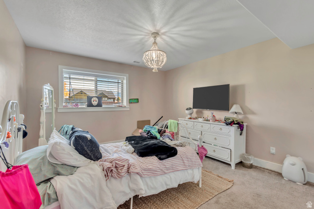 1071 Jamie-Matt Circle Layton, UT 84041 - Photo 5 of 28 Bedroom with light colored carpet and a chandelier