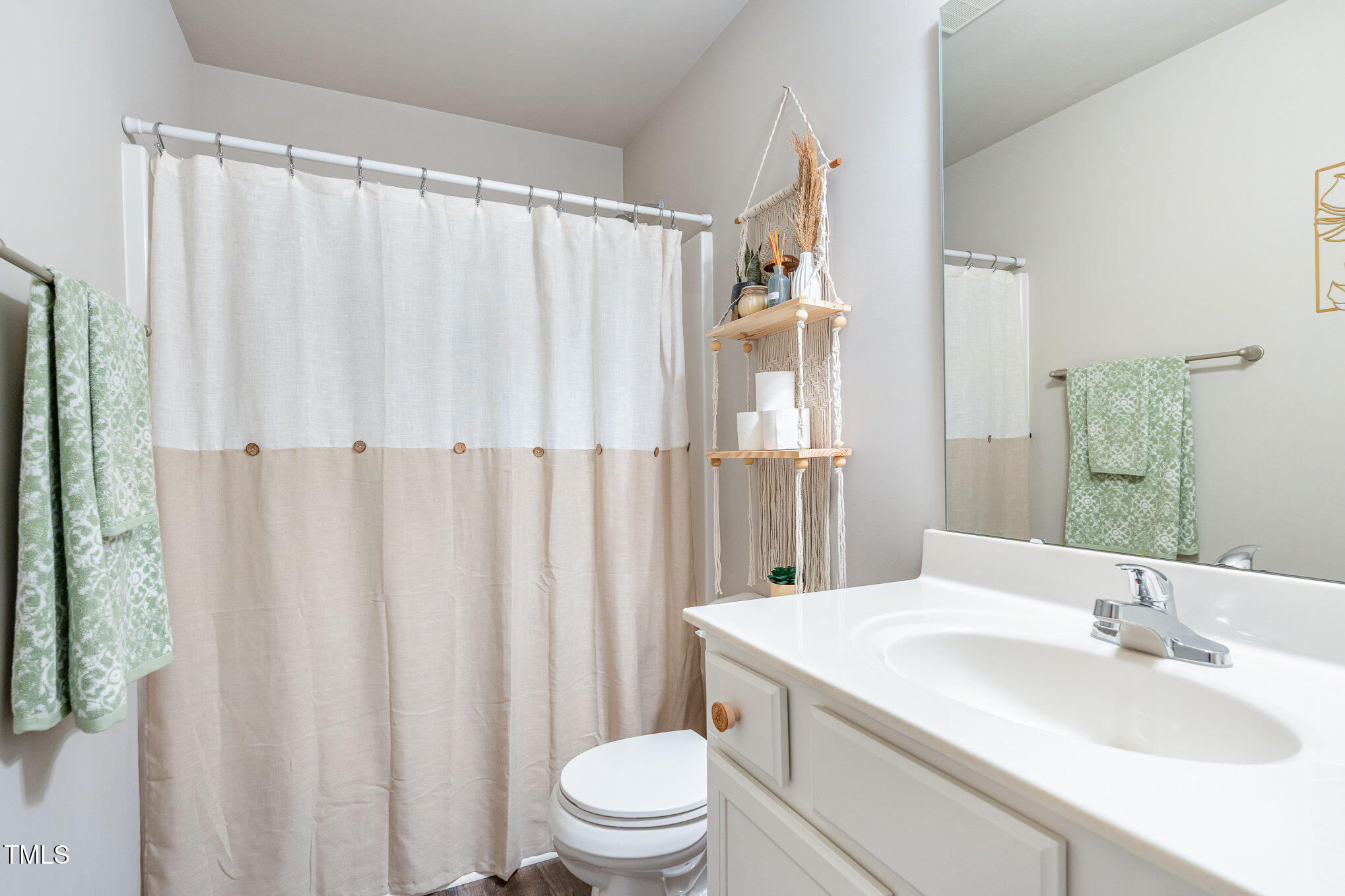 170 Willow Ridge Circle Willow Spring, NC 27592 - Photo 13 of 21 a bathroom with a sink a toilet and shower curtain