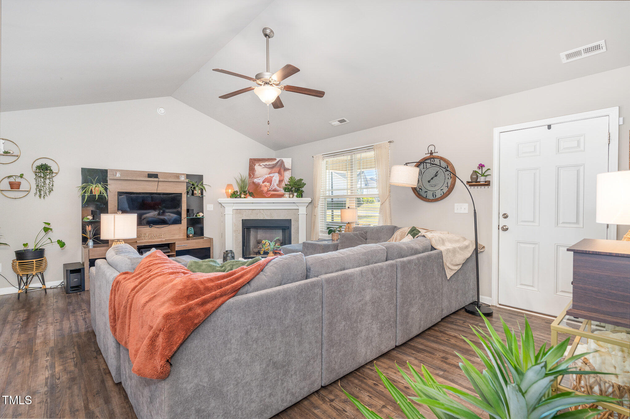 170 Willow Ridge Circle Willow Spring, NC 27592 - Photo 5 of 21 a living room with furniture a fireplace and a flat screen tv
