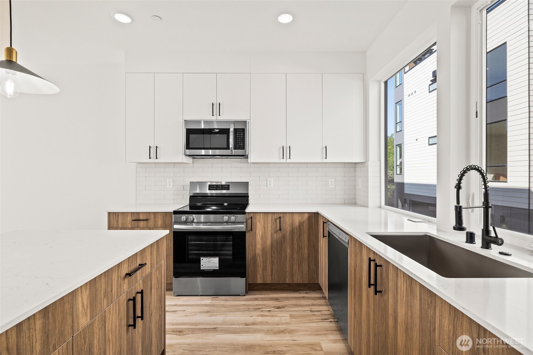 8322 16th Avenue Northwest, Unit D Seattle, WA 98117 - Photo 11 of 24 a kitchen with sink a stove and cabinets