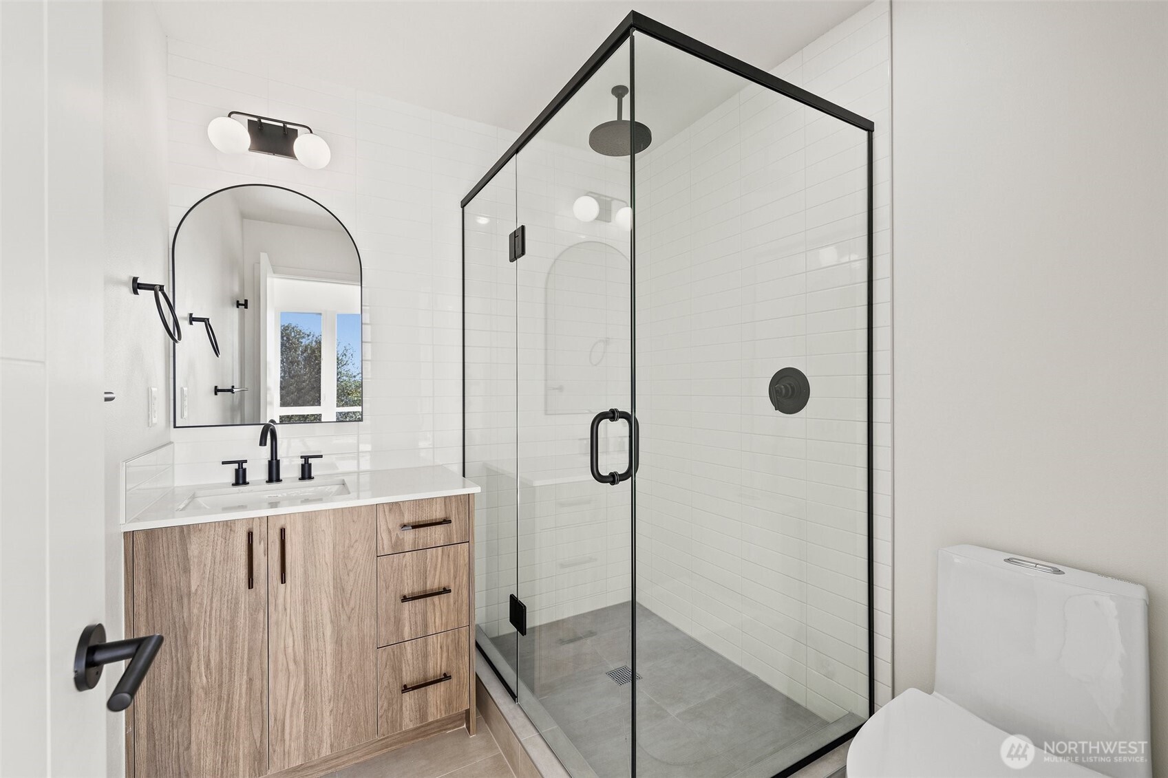 8322 16th Avenue Northwest, Unit D Seattle, WA 98117 - Photo 14 of 24 a bathroom with a double vanity sink mirror and shower