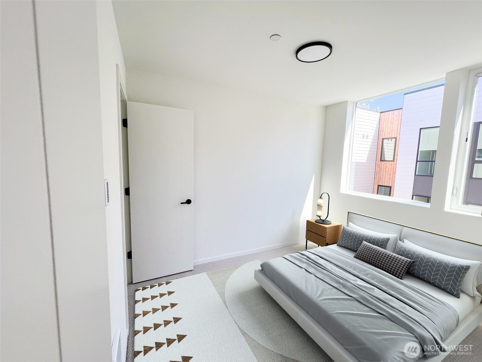 8322 16th Avenue Northwest, Unit D Seattle, WA 98117 - Photo 15 of 24 a bedroom with bed and wooden floor