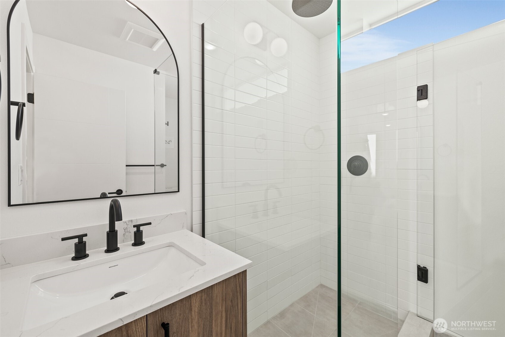8322 16th Avenue Northwest, Unit D Seattle, WA 98117 - Photo 16 of 24 a bathroom with a sink vanity and a mirror