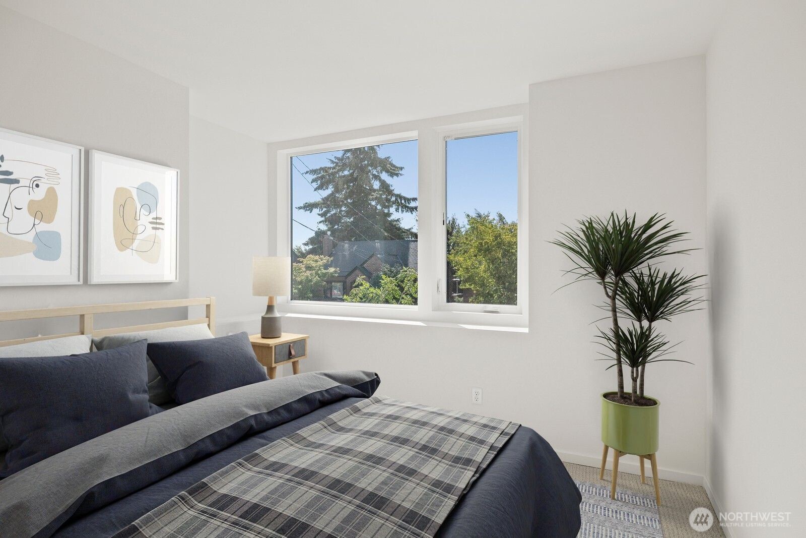 8322 16th Avenue Northwest, Unit D Seattle, WA 98117 - Photo 20 of 24 a bedroom with furniture and a large window