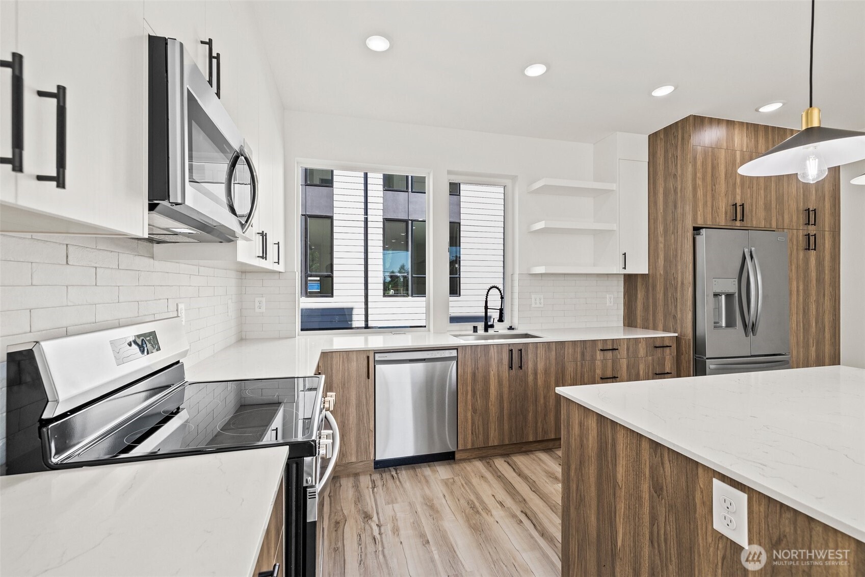8322 16th Avenue Northwest, Unit D Seattle, WA 98117 - Photo 8 of 24 a kitchen with stainless steel appliances granite countertop a sink stove and refrigerator