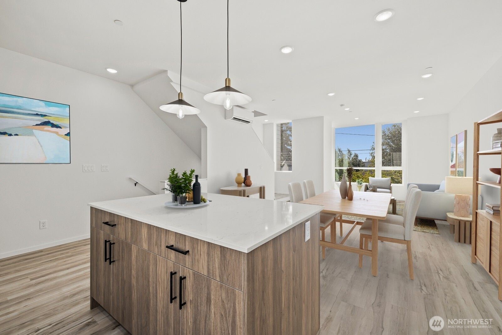 8322 16th Avenue Northwest, Unit D Seattle, WA 98117 - Photo 9 of 24 a view of kitchen island with stainless steel appliances furniture large window and wooden floor