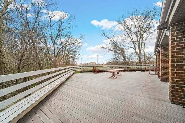 a view of roof deck with seating space and wooden floor