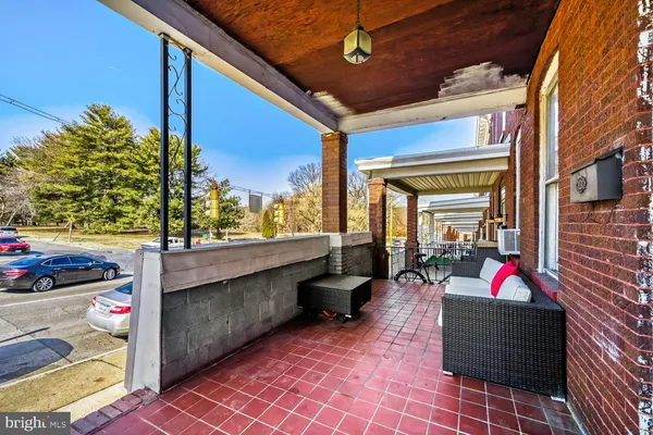 a backyard of a house with barbeque oven table and chairs