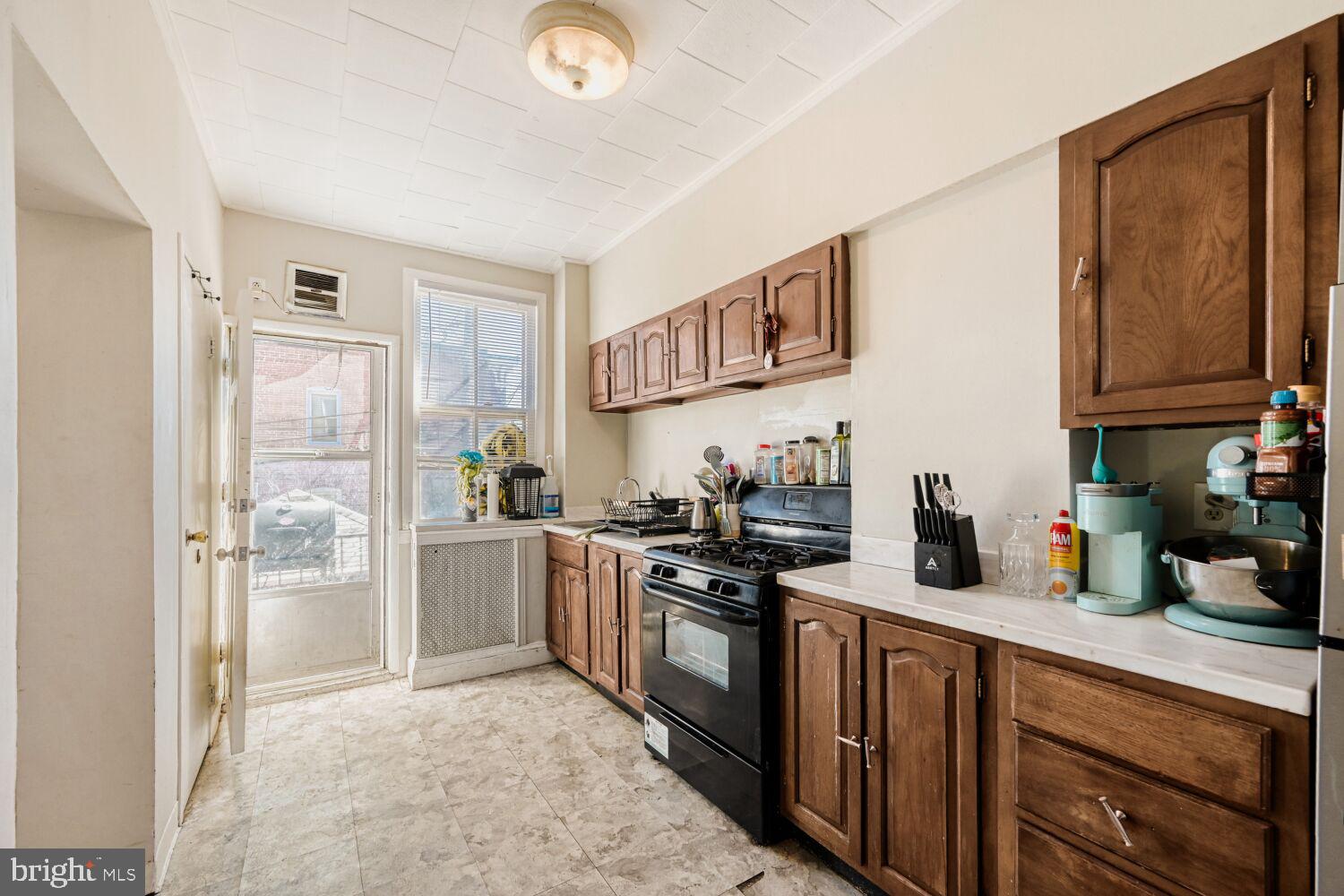 3703 Belair Road Baltimore, MD 21213 - Photo 6 of 22 a kitchen with a sink stove and refrigerator