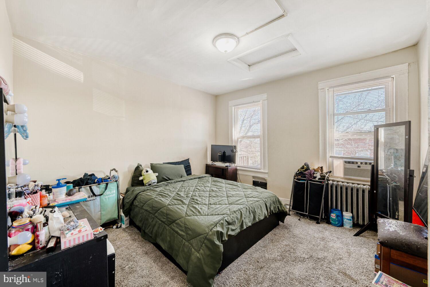 3703 Belair Road Baltimore, MD 21213 - Photo 9 of 22 a bedroom with a bed a couch and a potted plant