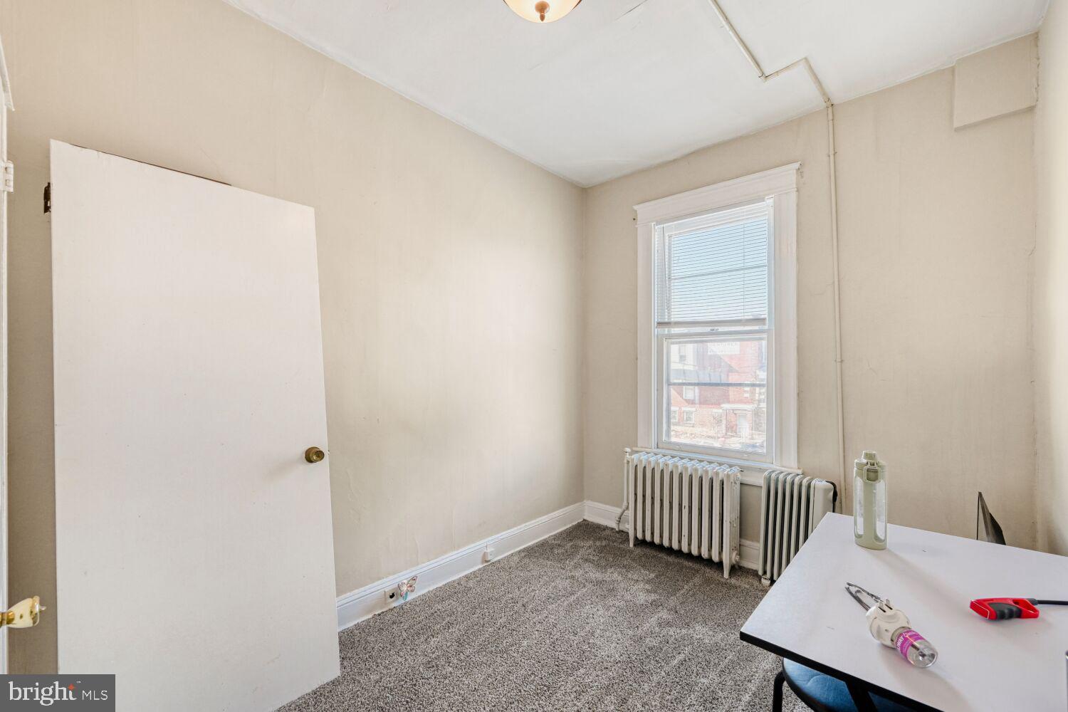 3703 Belair Road Baltimore, MD 21213 - Photo 10 of 22 a bedroom with a bed and a window