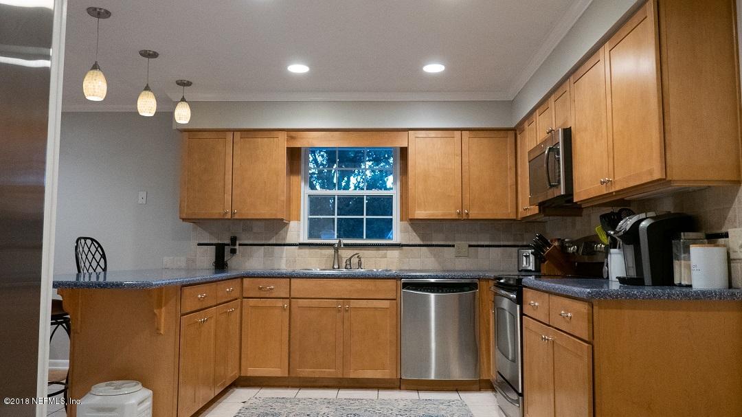 8918 San Rae Road Jacksonville, FL 32257 - Photo 18 of 33 a kitchen with granite countertop a sink cabinets and window