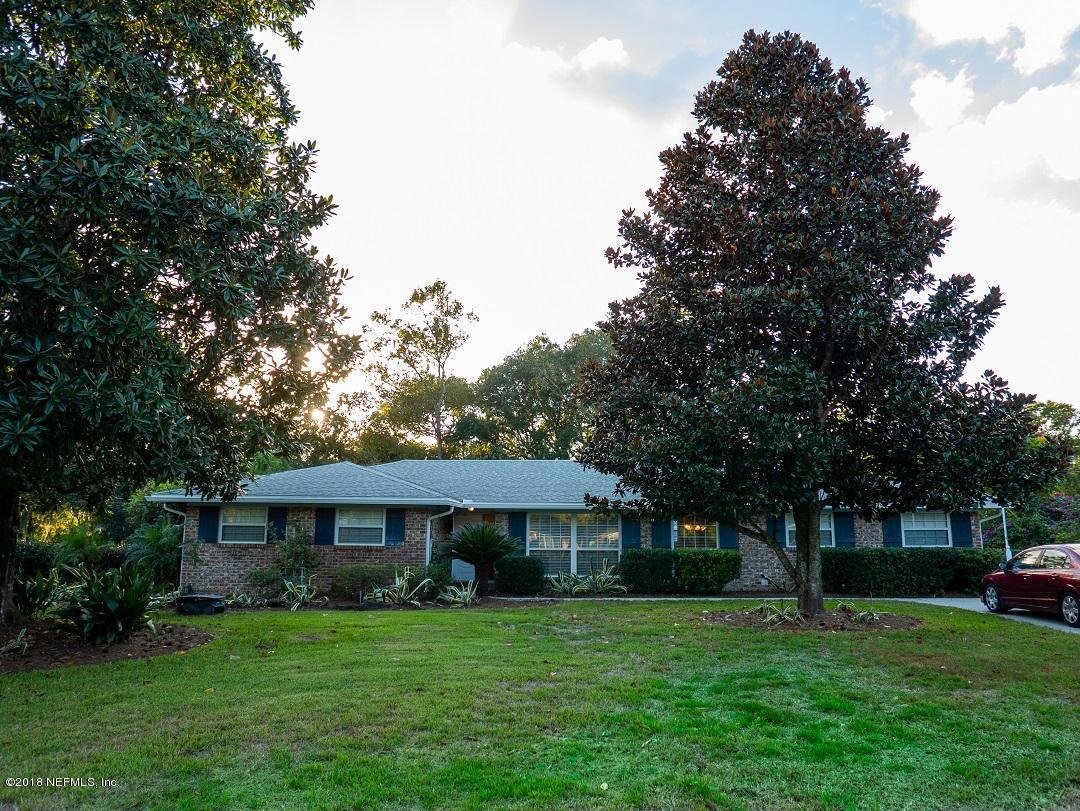 8918 San Rae Road Jacksonville, FL 32257 - Photo 2 of 33 a view of a big house with a big yard and large trees