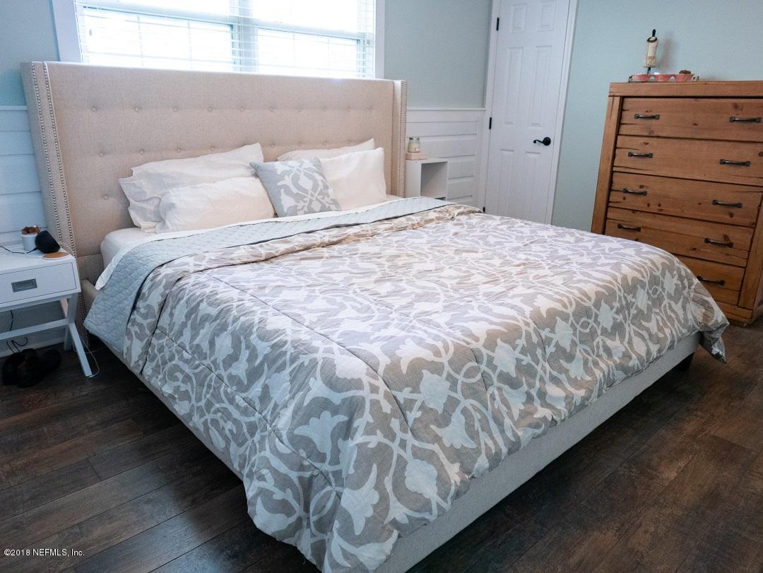 8918 San Rae Road Jacksonville, FL 32257 - Photo 27 of 33 a large bed sitting in a bedroom next to a window