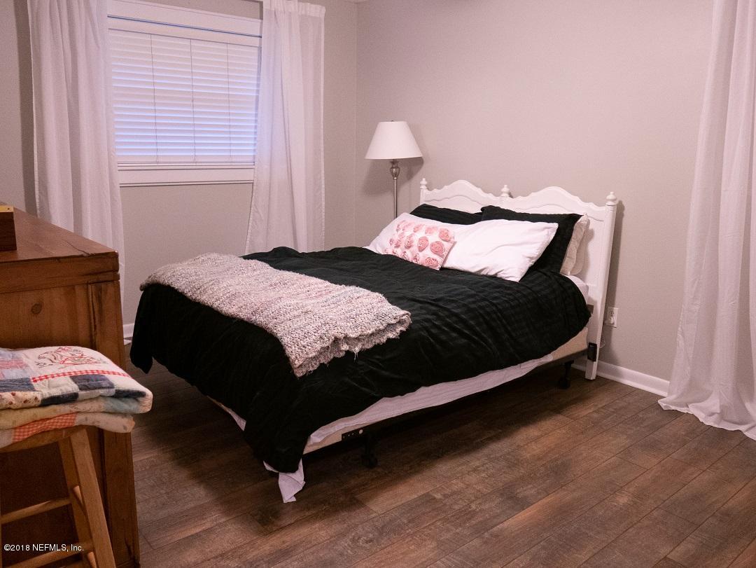 8918 San Rae Road Jacksonville, FL 32257 - Photo 30 of 33 a bedroom with a bed and a window