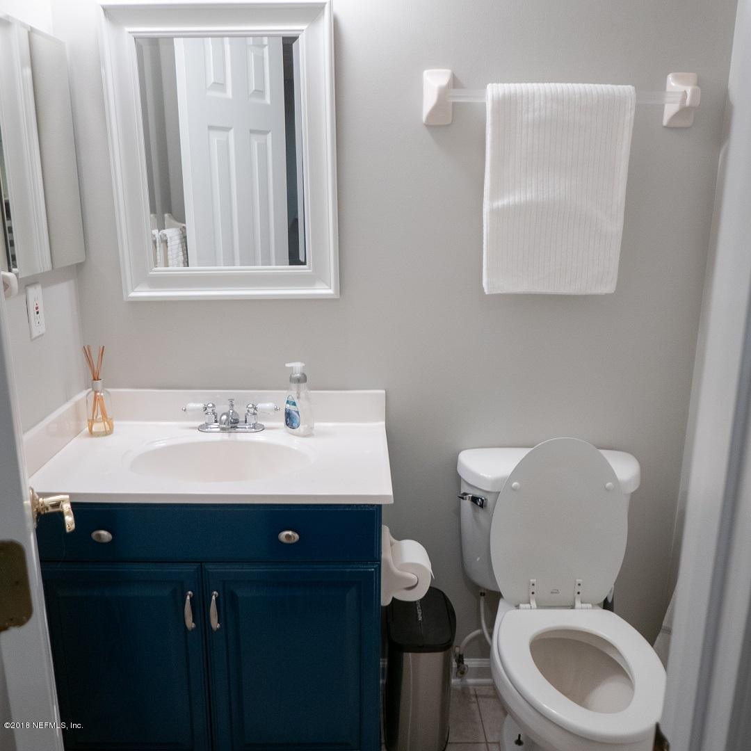 8918 San Rae Road Jacksonville, FL 32257 - Photo 31 of 33 a bathroom with a toilet a sink and mirror