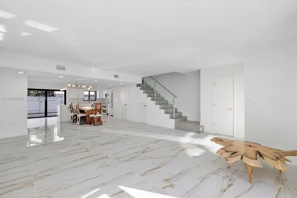 a view of a livingroom with dining room and wooden floor