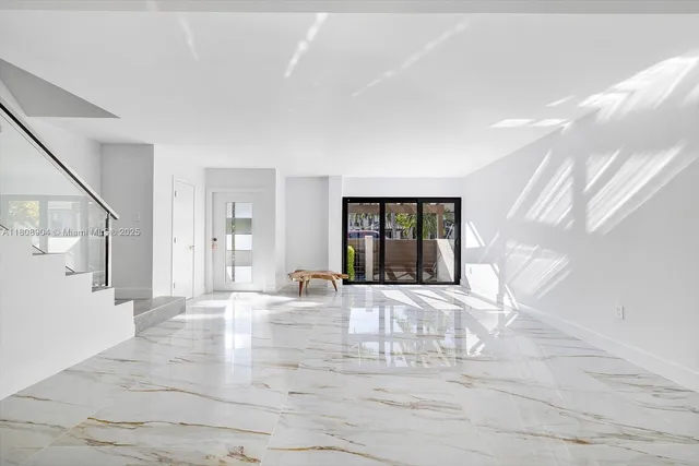 a view of a livingroom with wooden floor and stairs
