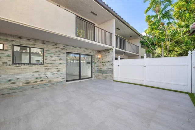a view of a house with a small yard and plants