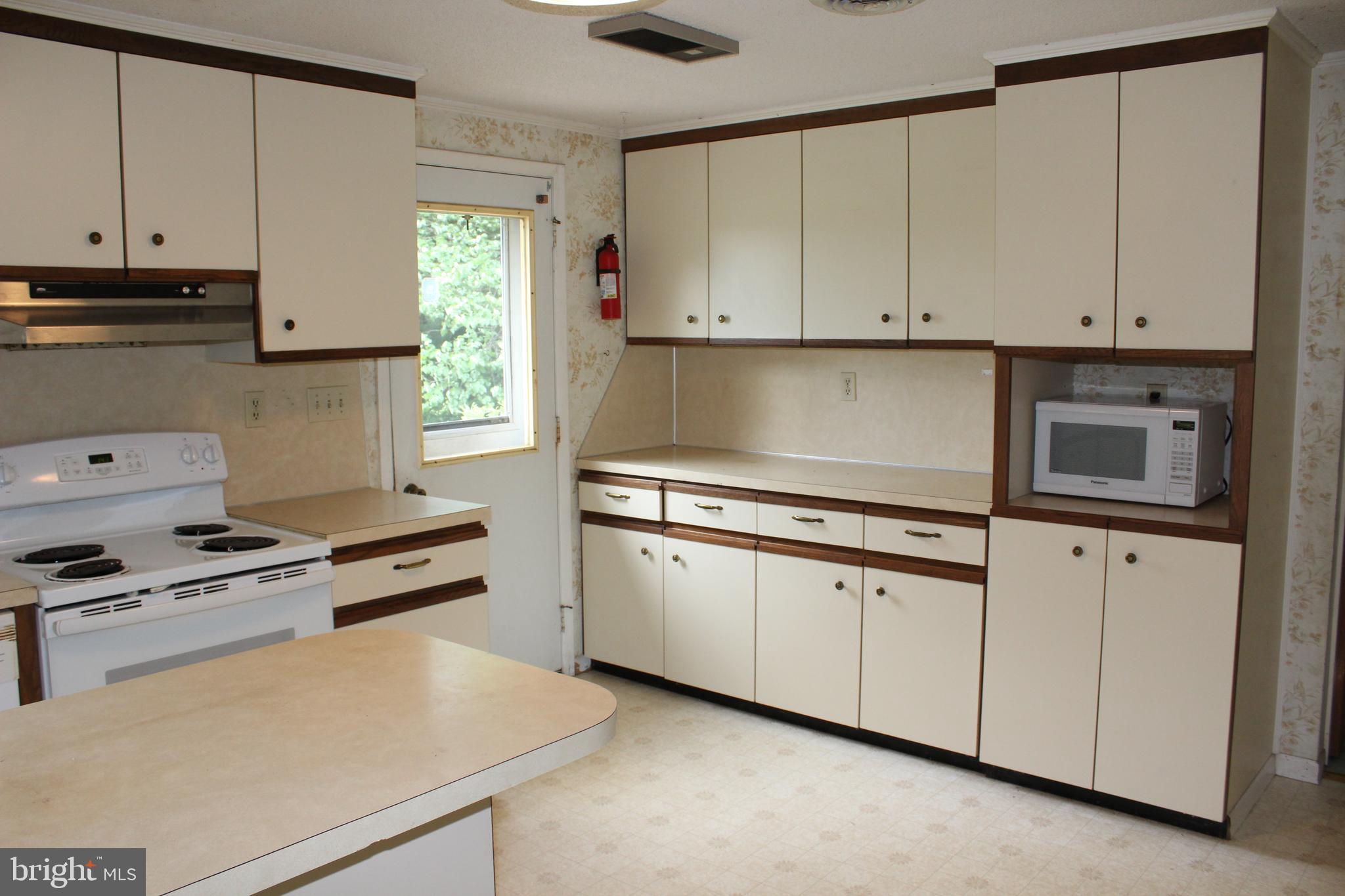 801 Boyle Road Fairfield, PA 17320 - Photo 23 of 38 a kitchen with granite countertop white cabinets and white appliances