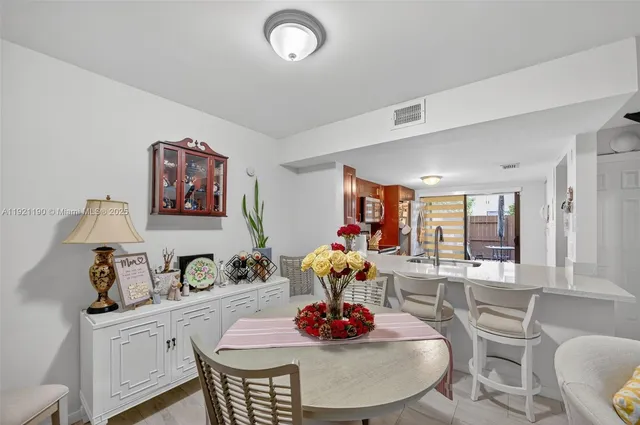 a dining room with furniture and window