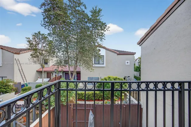 a view of a balcony with wooden fence and floor