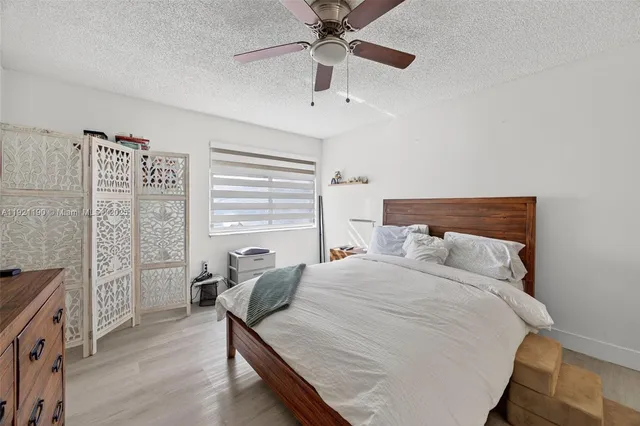 a bed room with a bed and a chandelier