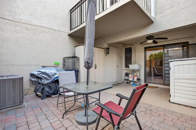 a view of a chairs and table in backyard of the house