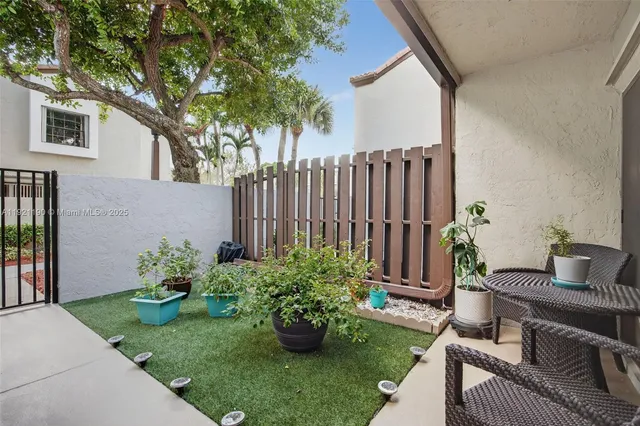 a view of a backyard with couches and a potted plant