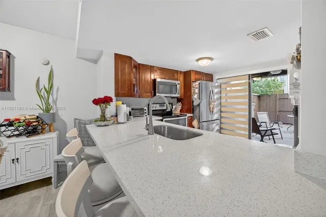 a living room with furniture a flat screen tv and a large window