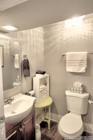 a bathroom with a sink mirror and toilet