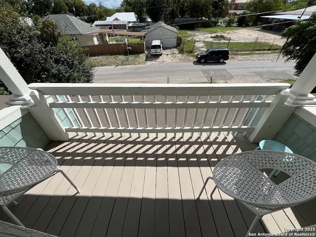 a balcony view with a couple of chairs