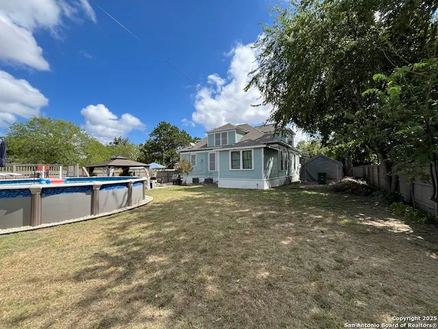 a view of swimming pool with a yard