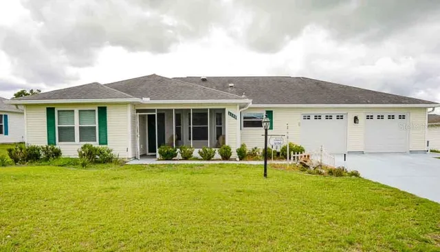 a view of a house with a backyard