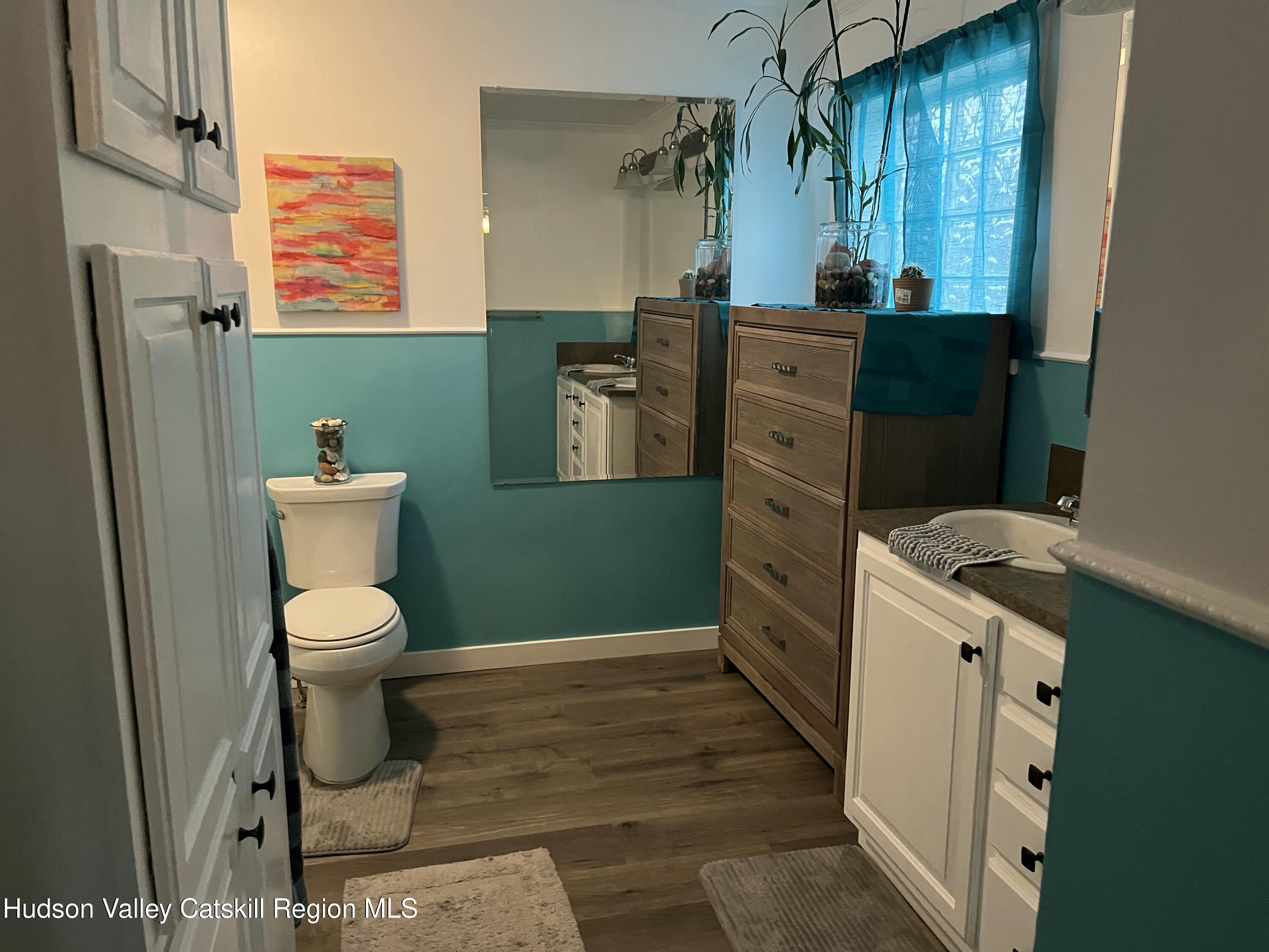 13 Mahoney Road Stuyvesant, NY 12173 - Photo 15 of 19 a bathroom with a toilet a sink a window and mirror