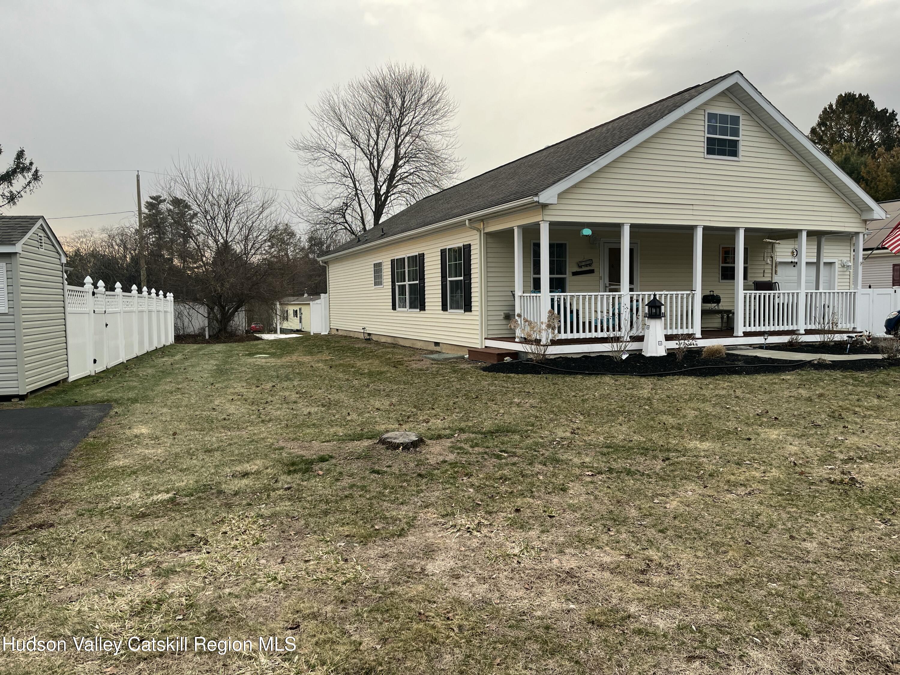 13 Mahoney Road Stuyvesant, NY 12173 - Photo 17 of 19 a front view of a house with a yard table and chairs