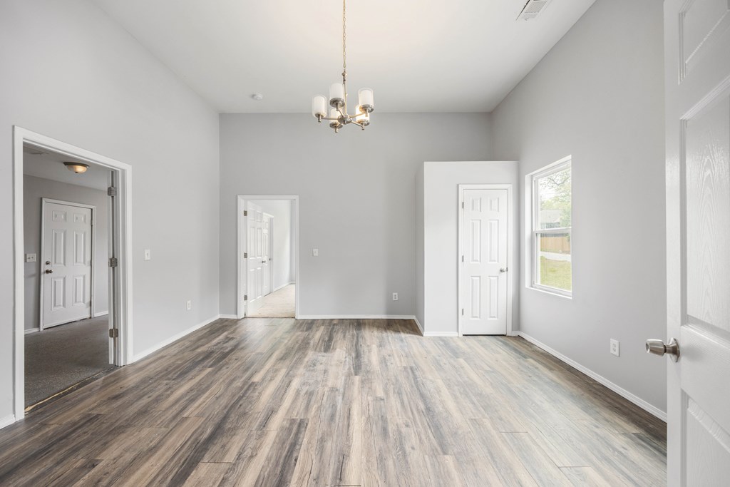 2113 Summerville Road Phenix City, AL 36867 - Photo 18 of 37 wooden floor in an empty room with a window