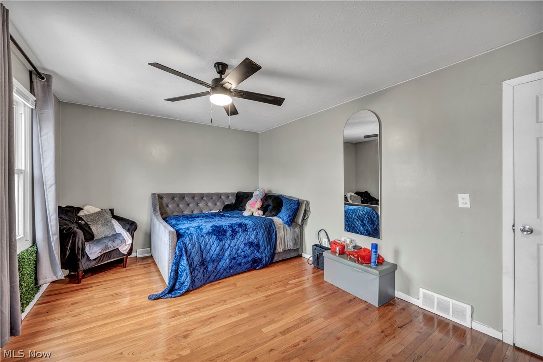 13800 Milo Road Garfield Heights, OH 44125 - Photo 14 of 39 Bedroom with hardwood / wood-style flooring and a ceiling fan
