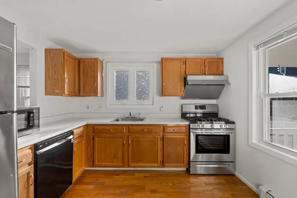a kitchen with stainless steel appliances a stove a sink and a microwave