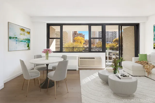 a view of a dining room with furniture large windows and wooden floor