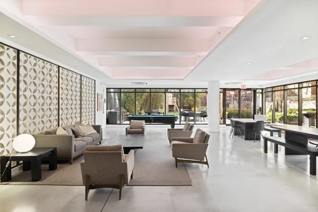 a living room with fireplace furniture and a large window