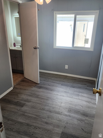 332 Joshua Street Tooele, UT 84074 - Photo 6 of 16 Interior room featuring wood-finish flooring and light gray paneling
