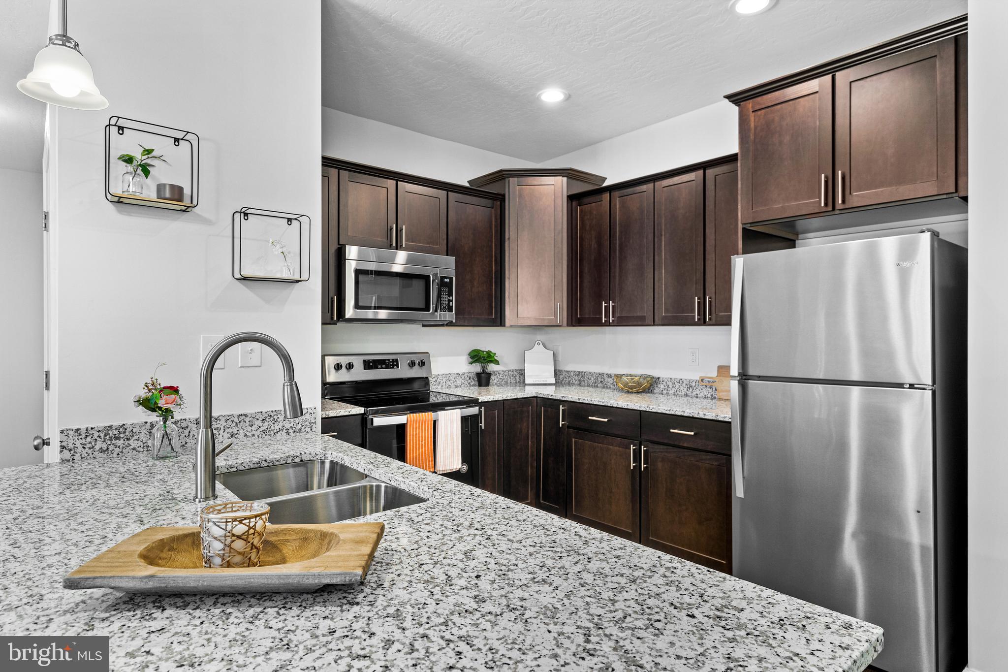 1014 Admiral Lane, Unit 9 Hanover, PA 17331 - Photo 6 of 36 a kitchen with kitchen island a sink appliances and cabinets