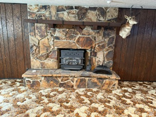 588 North 4500 West West Point, UT 84015 - Photo 31 of 61 Stone-clad fireplace with a hearth, featuring a wood-burning stove insert