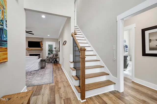 a living room with furniture a flat screen tv and a fireplace