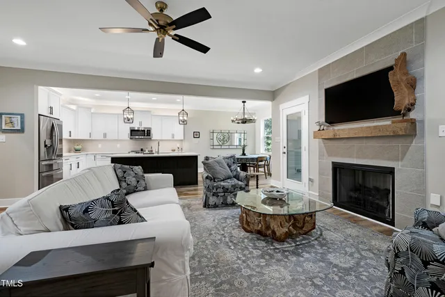 a kitchen with stainless steel appliances granite countertop stove a table and chairs with wooden floor