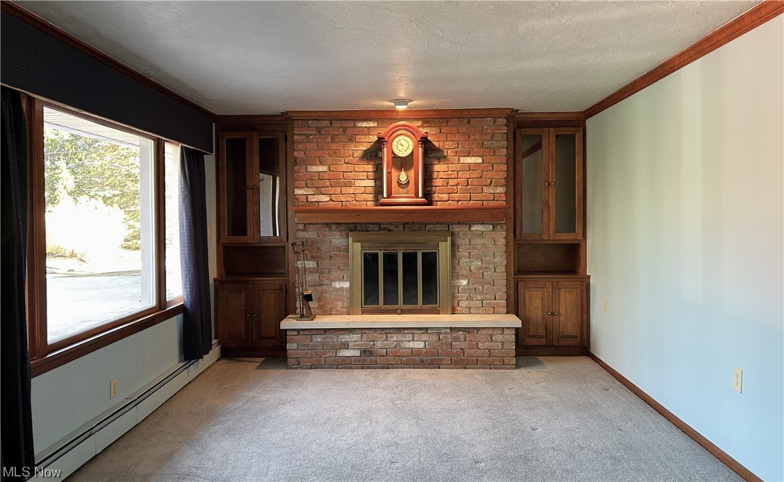 7855 Mulberry Road Chesterland, OH 44026 - Photo 12 of 46 Living Room with a fireplace of brick, Cherry mantel, sandstone hearth, and crown molding. Notice the built ins on either side of the fireplace.