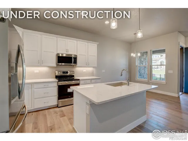 a kitchen with a sink stainless steel appliances and white cabinets