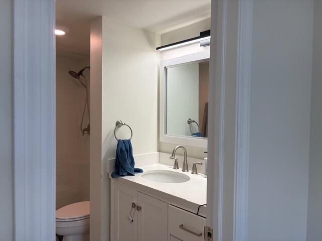 21906 Lake Forest Circle Boca Raton, FL 33433 - Photo 13 of 20 a bathroom with a toilet sink and mirror