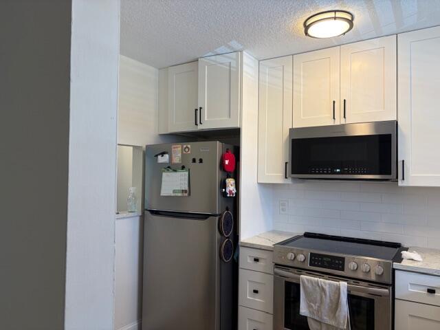21906 Lake Forest Circle Boca Raton, FL 33433 - Photo 3 of 20 a kitchen with stainless steel appliances granite countertop a refrigerator and a stove top oven